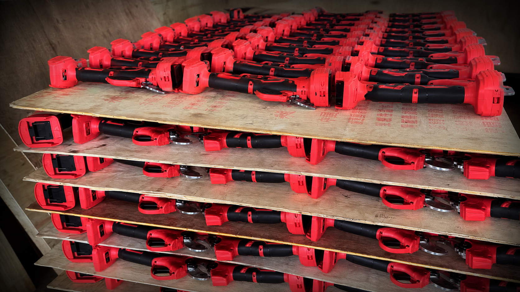 Red electric pruning shears arranged in batches for shipment